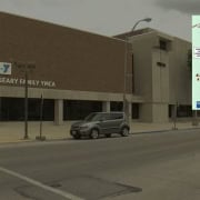 Fostoria News Geary Family YMCA building with Empower Her event poster on the side.
